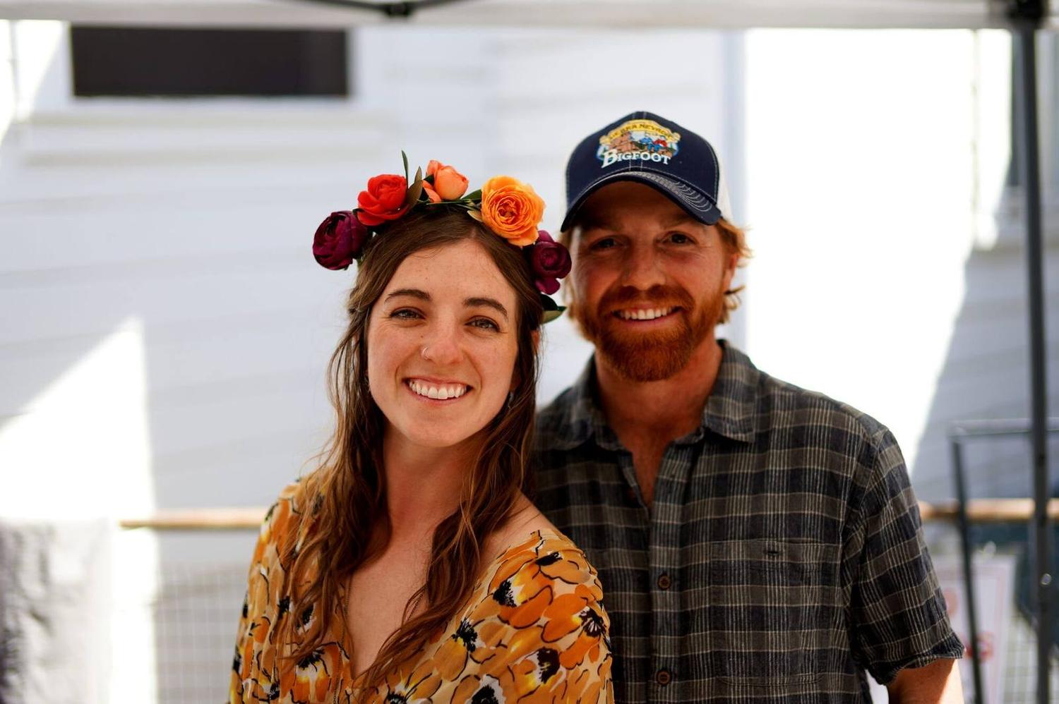 Two people at a spring festival, one in a flower crown